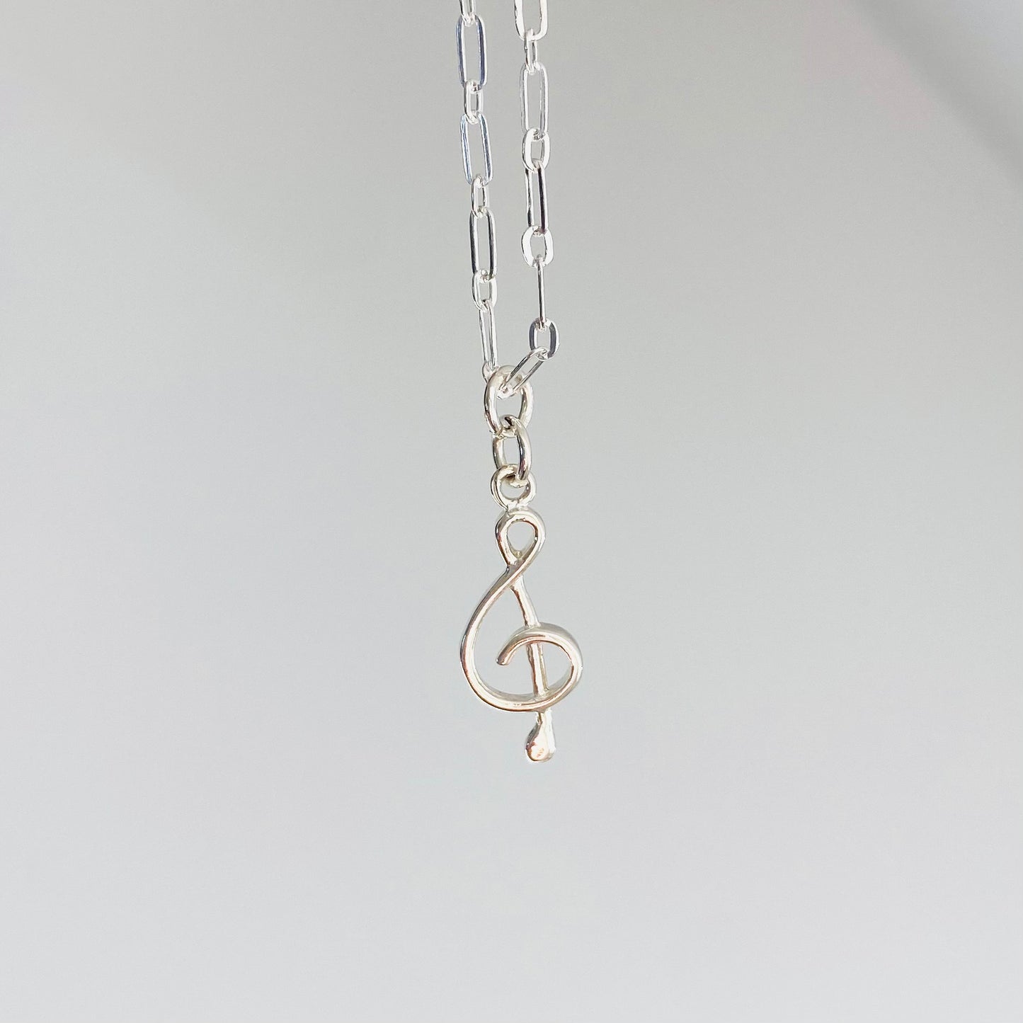 Treble clef necklace