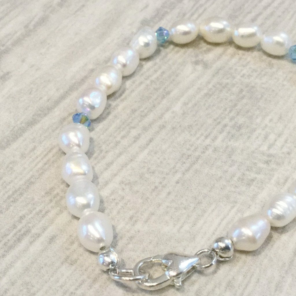 Ivory freshwater cultured pearl bracelet with blue swarovski crystal elements