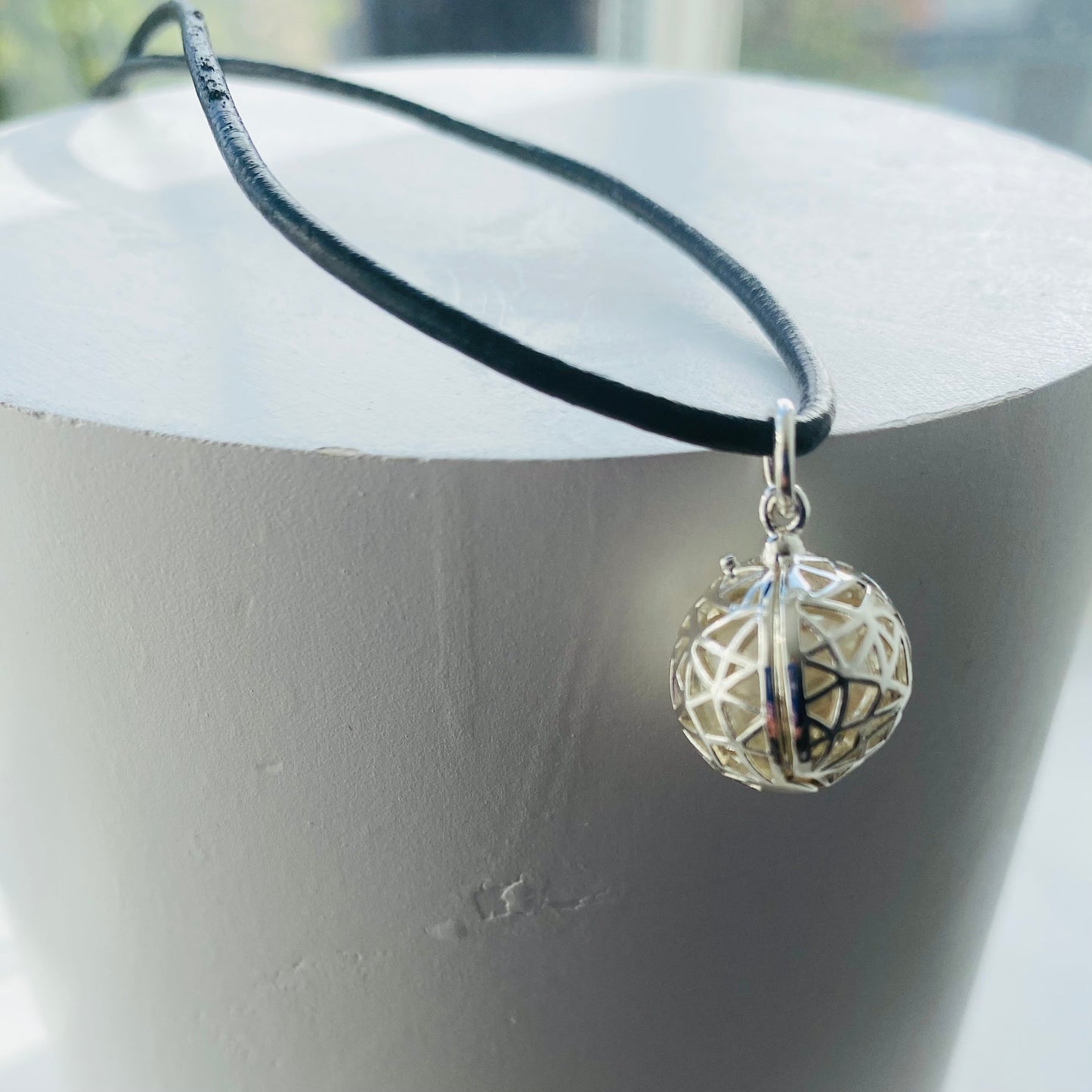 Hidden pearl silver plated cage pendant