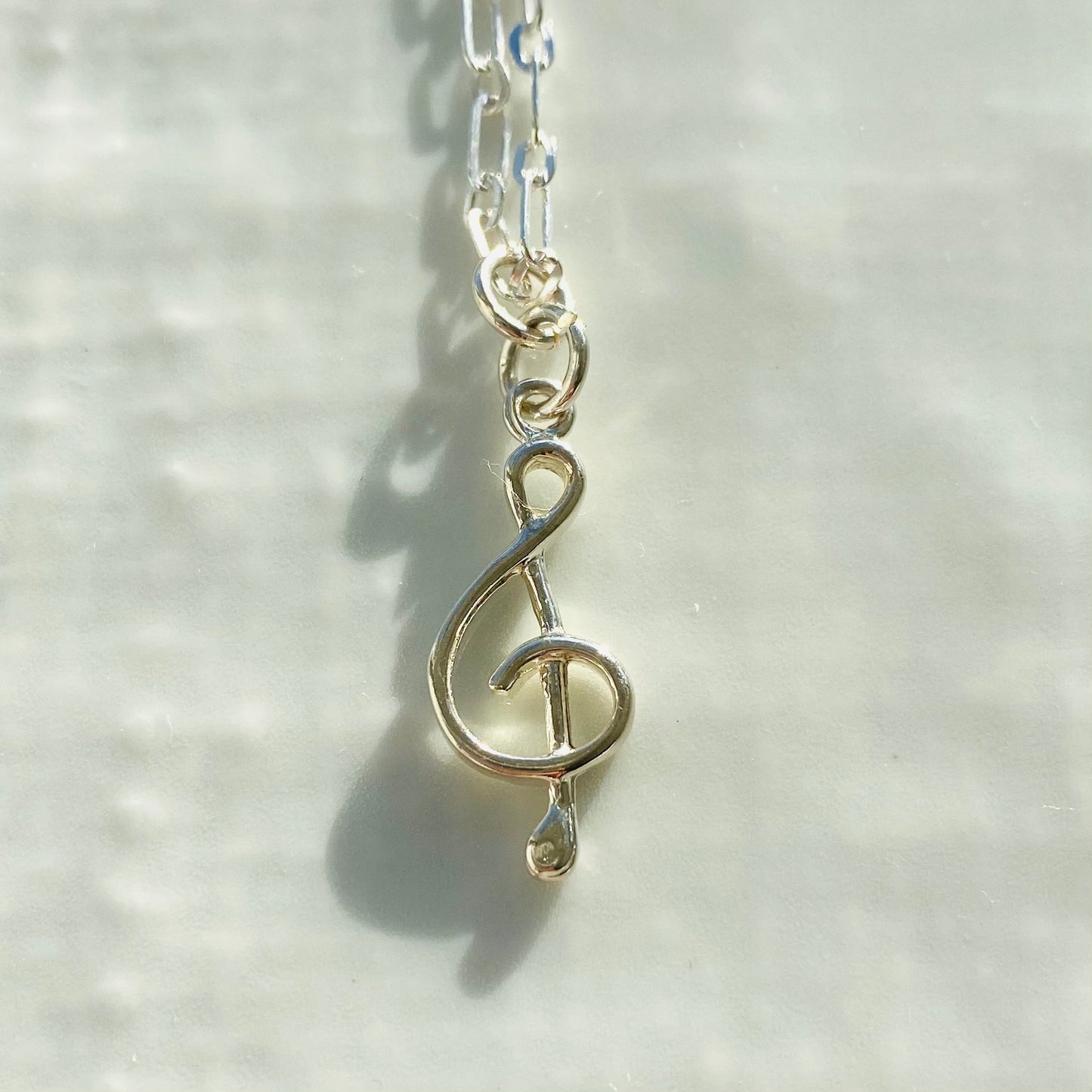 Treble clef necklace